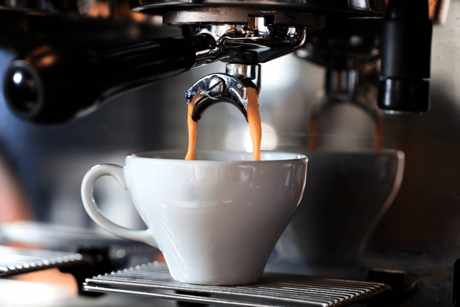 espresso machine making espresso in a white cup